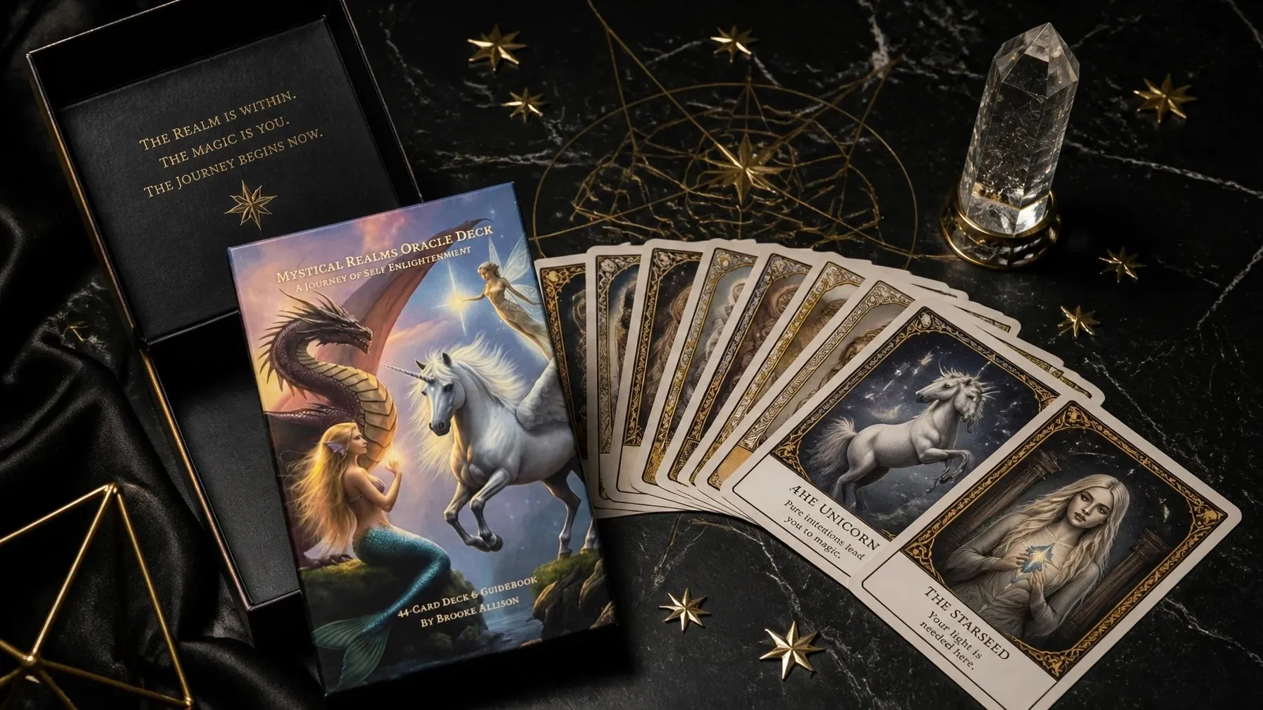 Mystical Realms Oracle Deck cards and box surrounded by celestial details